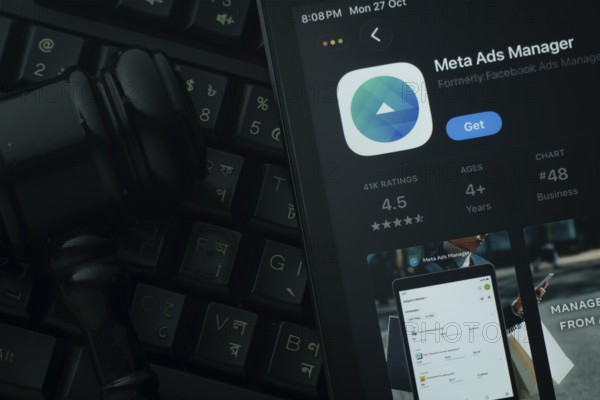 Dhaka, Bangladesh- 28 Oct 2025: An iPad displaying the meta ads manager app against a judge's gavel and dark keyboard background
