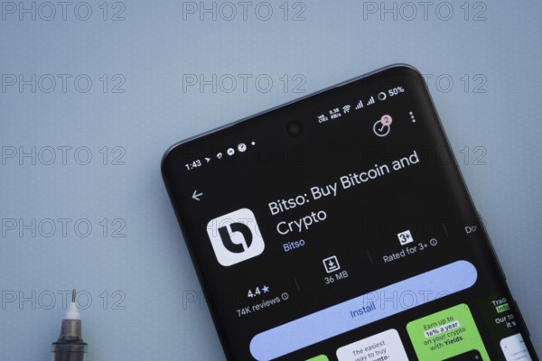 Dhaka, Bangladesh- 29 May 2025: On a blue surface, a smartphone displays the Bitso app within the Google Play Store