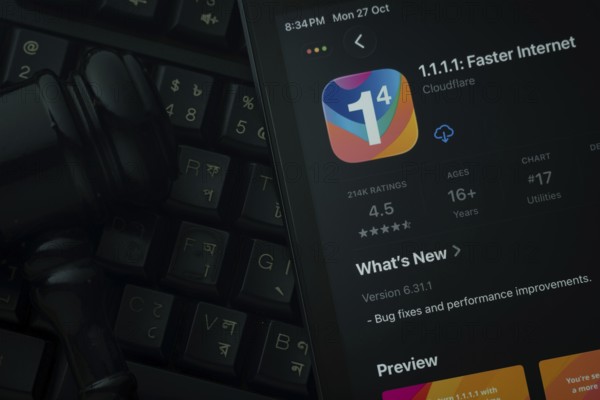 Dhaka, Bangladesh- 28 Oct 2025: An iPad displaying the 1.1.1.1 VPN app against a judge's gavel and dark keyboard background