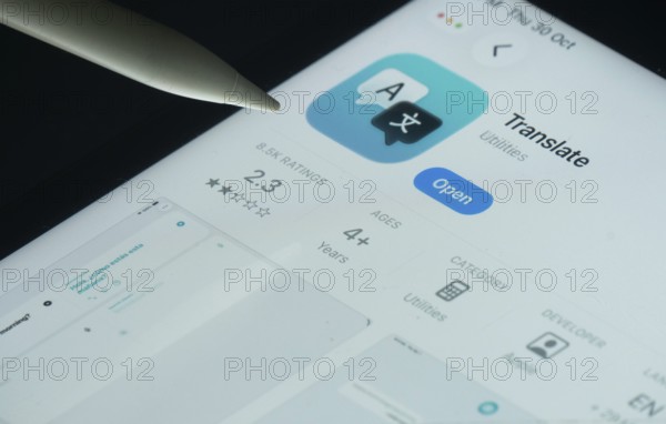 Dhaka, Bangladesh- 30 Oct 2025: Apple Translate app on a iPad screen with a pen pointing at the install option