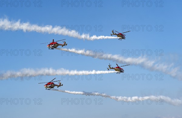Indian Air Force (IAF) ALH Mk1 Sarang helicopters soar through the sky during an air show as part of the 93rd Air Force Day celebrations on November 8, 2025 in Guwahati, India