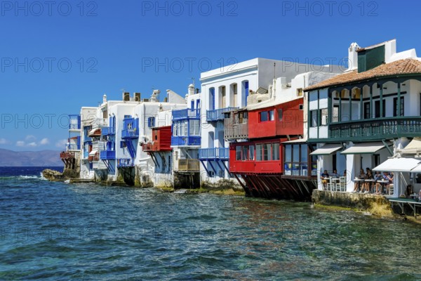Mykonos, Cyclades, Greece - Little Venice is a picturesque neighborhood in Mykonos Town with colorful houses that stand right by the sea and are reminiscent of Venice. Little Venice is located on Alefkandra Bay next to the famous windmills of Mykonos. Mykonos is part of the Cyclades archipelago in the Aegean Sea