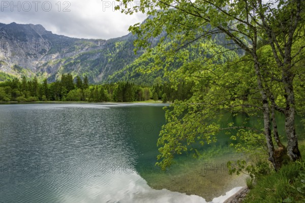 Landscape of Lake Offensee after rain when the sun comes through the clouds in spring, Salzkammergut, Austria