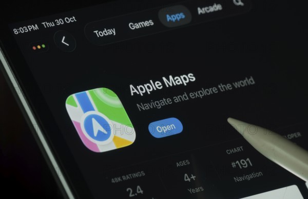 Dhaka, Bangladesh- 30 Oct 2025: Apple Maps app displayed on a iPad screen in dark mode with a digital pen pointing at it
