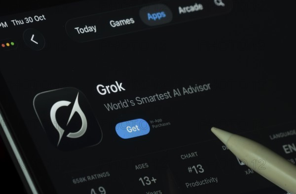 Dhaka, Bangladesh- 30 Oct 2025: Grok Ai app displayed on a iPad screen in dark mode with a digital pen pointing at it