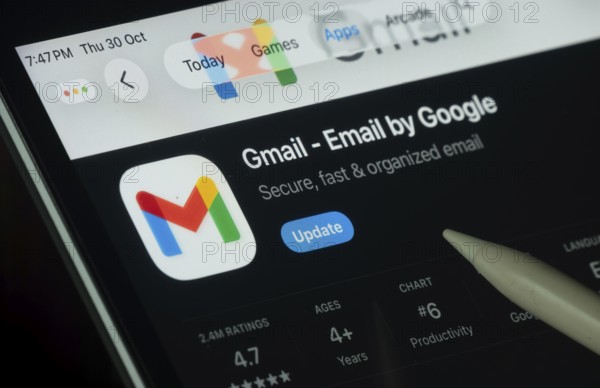 Dhaka, Bangladesh- 30 Oct 2025: Gmail app displayed on a iPad screen in dark mode with a digital pen pointing at it