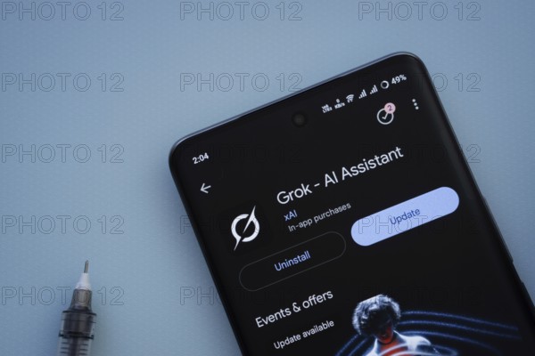 Dhaka, Bangladesh- 29 May 2025: On a blue surface, a smartphone displays the Grok Ai app within the Google Play Store