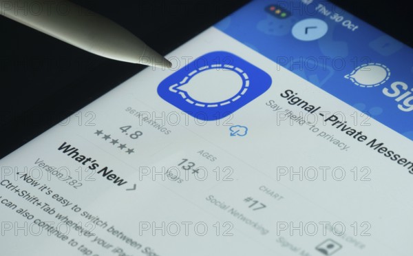 Dhaka, Bangladesh- 30 Oct 2025: Signal app on a iPad screen with a pen pointing at the install option