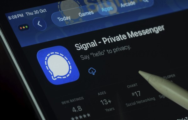 Dhaka, Bangladesh- 30 Oct 2025: Signal app displayed on a iPad screen in dark mode with a digital pen pointing at it