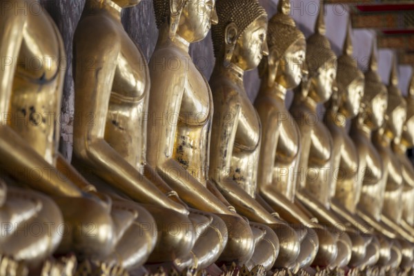 Gilded Buddha statues (Bhumispara mudra: Buddha Gautama at the moment of enlightenment), Wat Suthat Thepwararam, Royal Temple, Phra Nakhon, Bangkok, Thailand