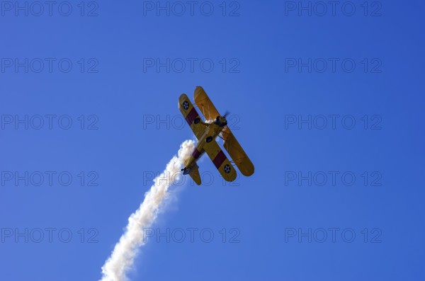 A Boeing PT-17 Stearman biplane, also Boeing Stearman Model 75, with the inscription 399 USNAVY N67193 during a flight demonstration as part of an air show on Rossfeld in Metzingen-Glems, Baden-Württemberg, Germany, for editorial use only