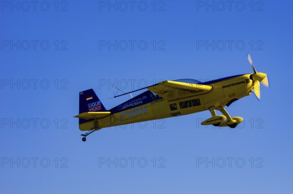 An Extra EA-300 from Extra Flugzeugproduktions- und Vertriebs GmbH with registration D-EXBH during a flight demonstration as part of an air show on Rossfeld in Metzingen-Glems, Baden-Württemberg, Germany, for editorial use only