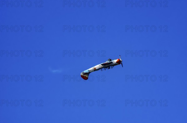A Jakovlev Jak-52 with registration LY-HLZ during a flight demonstration as part of an air show on Rossfeld in Metzingen-Glems, Baden-Württemberg, Germany, for editorial use only