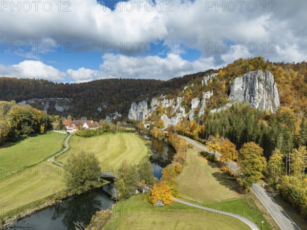 Aerial view of Käppeler Manor with St. George's Basilica near Thiergarten in the Upper Danube Valley, surrounded by autumn vegetation, on the right the raven rocks, climbing rocks, Jura limestone rocks, Sigmaringen district, Baden-Württemberg, Germany