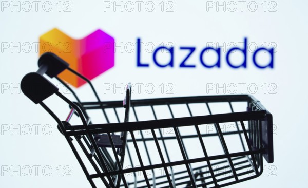 Dhaka, Bangladesh- 03 July 2025: Silhouette of a shopping cart in front of the Lazada logo, symbolizing ecommerce and online shopping