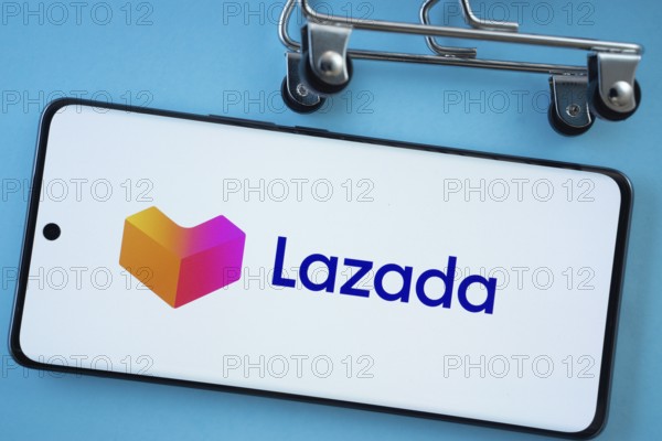 Dhaka, Bangladesh- 03 July 2025: Smartphone screen showing the Lazada logo with shopping cart wheels on a blue background