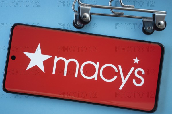 Dhaka, Bangladesh- 03 July 2025: Smartphone screen showing the Macy's logo with shopping cart wheels on a blue background