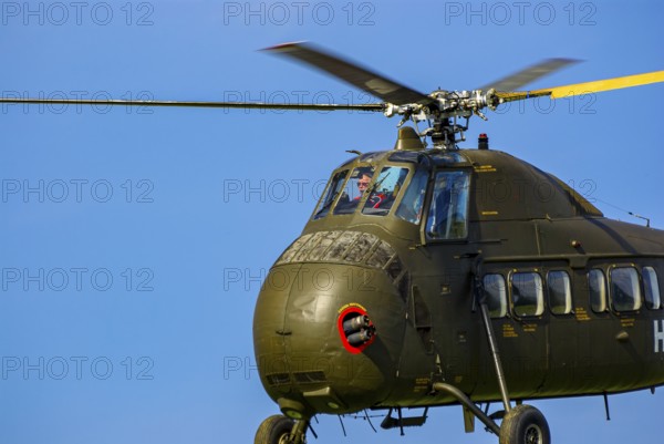 A Sikorsky S-58C transport helicopter in the colours of the German Army with the registration D-HAUG during a flight demonstration as part of an air show at the Rossfeld in Metzingen-Glems, Baden-Württemberg, Germany, for editorial use only