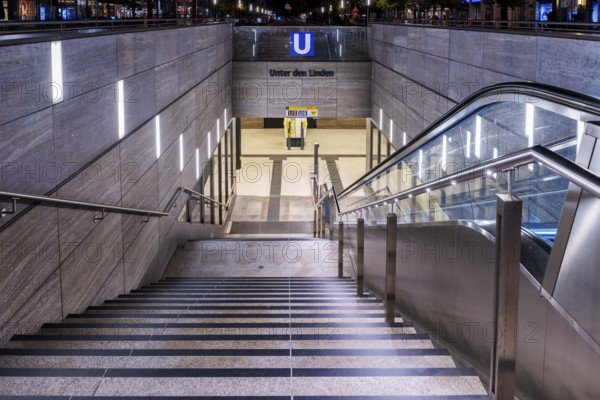 Night photo, long exposure with motion blur, modern underground entrance at Unter den Linden station, contemporary design with stairs and escalator, Berlin, Germany