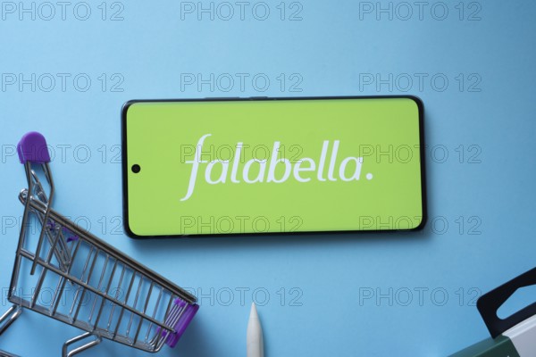 Dhaka, Bangladesh- 03 Oct 2025: Smartphone displaying Falabella. logo with shopping cart on a blue background