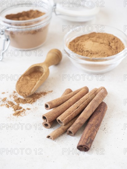 Aromatic cinnamon cassia sticks, ground powder, and a scoop for cooking and baking