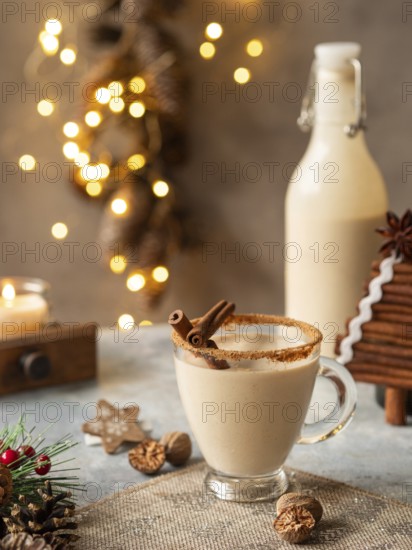 Creamy eggnog drink serving with cinnamon, nutmeg, and festive decor for holiday celebrations