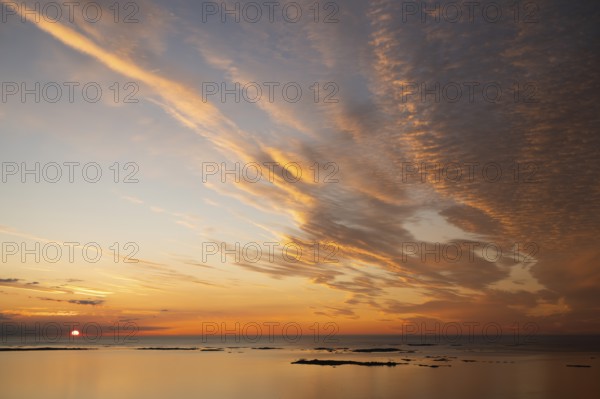 Offshore islands and skerries, sea, dramatically illuminated clouds, sunset, Otroya or Otrøya island, Møre og Romsdal, Norway