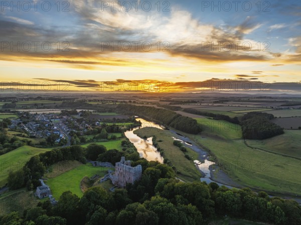 Sunset over Norham Castle and River Tweed from a drone, Norham, Northumberland, England, United Kingdom
