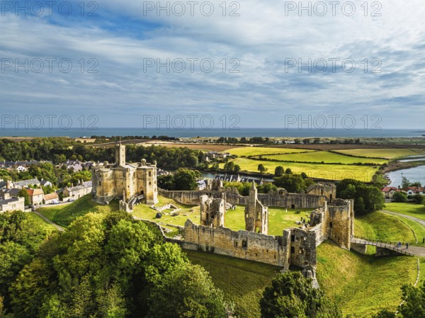 Warkworth Castle over River Coquet from a drone, Warkworth, Northumberland, England, United Kingdom