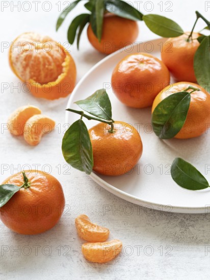 Vibrant tangerines with green leaves, showcasing freshness and citrusy appeal, perfect for healthy eating and seasonal recipes