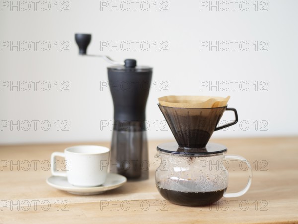 Brewing a fresh cup of filter coffee using a manual grinder and dripper