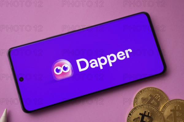 Dhaka, Bangladesh- 03 Oct 2025: Dapper logo on smartphone screen near Bitcoin coin and QR code on pink background