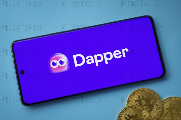 Dhaka, Bangladesh- 03 Oct 2025: Dapper logo on smartphone screen near Bitcoin coin and QR code on blue background