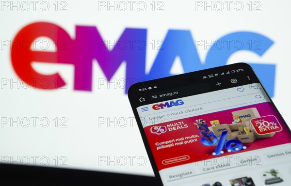 Dhaka, Bangladesh- 03 Oct 2025: Smartphone displaying Emag web interface against Emag logo background