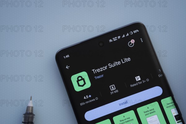 Dhaka, Bangladesh- 30 Sep 2025: On a blue surface, a smartphone displays the Trezor app with in the Google Play Store