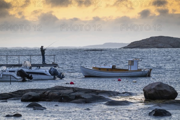 Small bay, archipelago, jetty with angler, Resö Island, Bohuslän, Skagerrak, Sotenäs, Västra Götalands län, Sweden