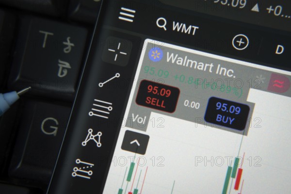 Dhaka, Bangladesh- 20 June 2025: Walmart Inc stock trading details on smartphone over a keyboard