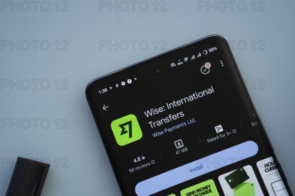 Dhaka, Bangladesh- 29 May 2025: On a blue surface, a smartphone displays the Wise app within the Google Play Store