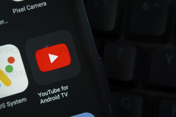 Dhaka, Bangladesh- 27 July 2025: Close-up of smartphone screen showing the youtube for android tv app icon with a dark interface