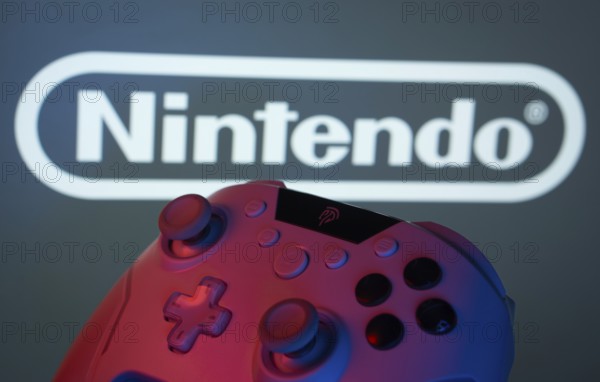Dhaka, Bangladesh- 15 July 2025: A close-up of a gamepad with the nintendo seen on screen in the background