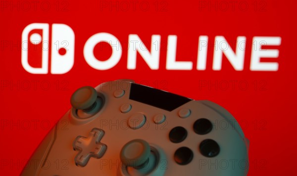Dhaka, Bangladesh- 15 July 2025: Game controller in front of nintendo online logo on a background