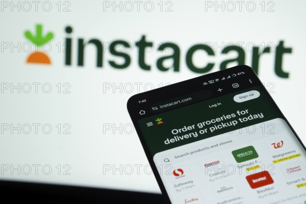 Dhaka, Bangladesh- 03 July 2025: Smartphone displaying Instacart web interface against Instacart logo background