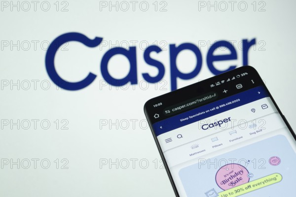 Dhaka, Bangladesh- 03 July 2025: Smartphone displaying Casper web interface against Casper logo background