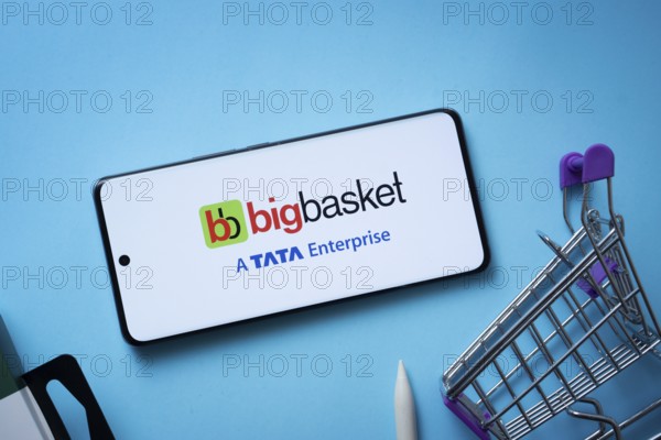 Dhaka, Bangladesh- 03 July 2025: Smartphone displaying BigBasket logo with shopping cart on a blue background
