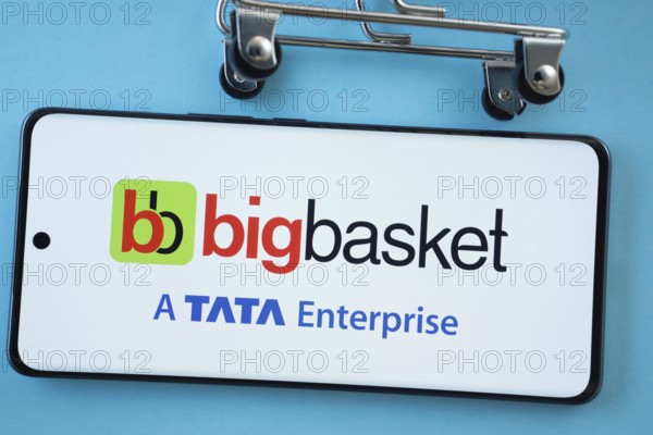 Dhaka, Bangladesh- 03 July 2025: Smartphone screen showing the BigBasket logo with shopping cart wheels on a blue background