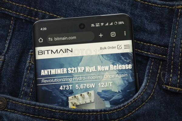 Dhaka, Bangladesh- 15 June 2025: A smartphone displaying the Bitmain.com web interface peeks out of a denim pocket