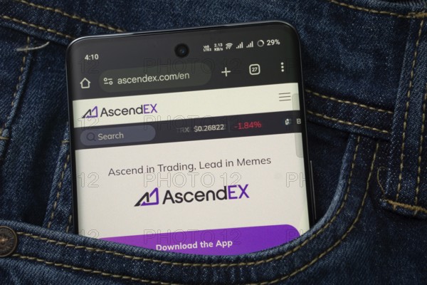 Dhaka, Bangladesh- 15 June 2025: A smartphone displaying the AscendEX web interface peeks out of a denim pocket