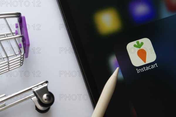 Dhaka, Bangladesh- 05 Sep 2025: A close up of an iPad screen displaying the instacart app alongside a mini shopping cart
