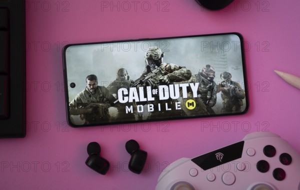 Dhaka, Bangladesh- 06 Sep 2025: A close-up of a gamepad with the Call of Duty Mobile seen on smartphone