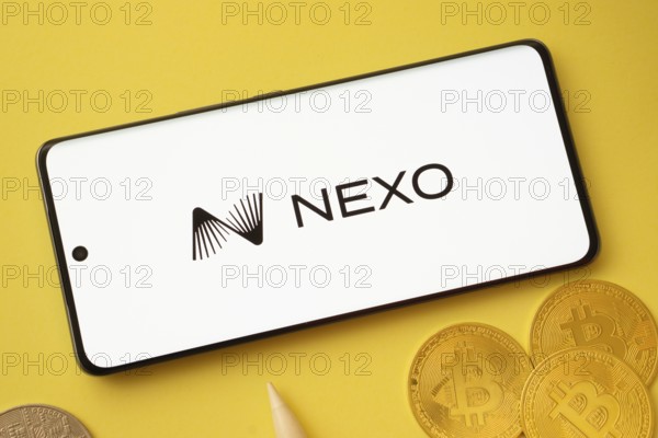 Dhaka, Bangladesh- 06 Sep 2025: Nexo logo on smartphone screen near Bitcoin coin and QR code on background